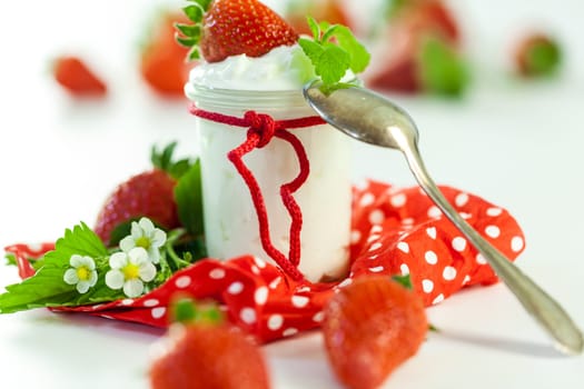 Fresh yoghurt with strawberries in a glass insulated on a white background