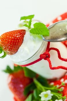 Fresh yoghurt with strawberries in a glass insulated on a white background