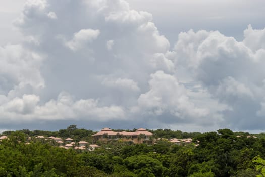 House roof in a plantation in a rich vegetation with cloudy skies in Singapore