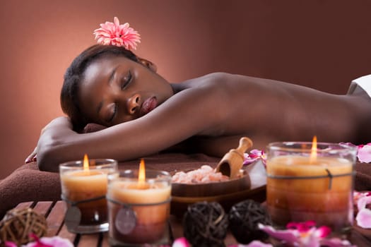 Side view portrait of smiling young woman relaxing at beauty spa