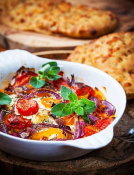 Baked feta cheese with vegetables and olive bread