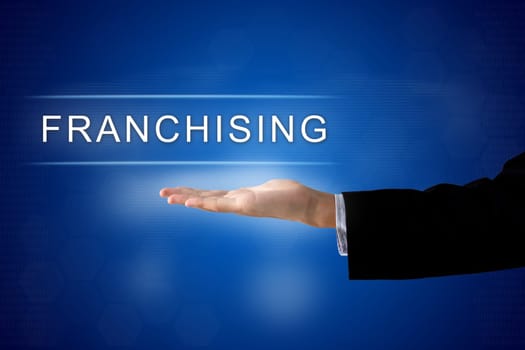 franchising button with business hand on a touch screen interface