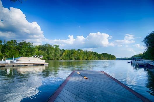 boats at dock on a lake with blue sky