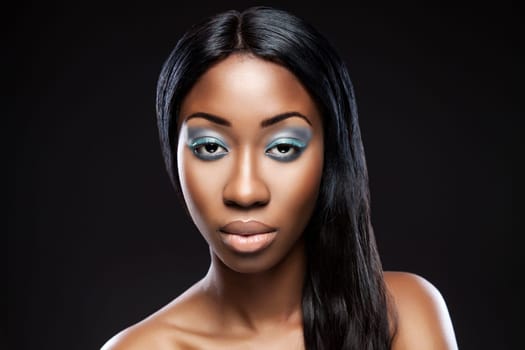 Beautiful young black woman with makeup and long hair
