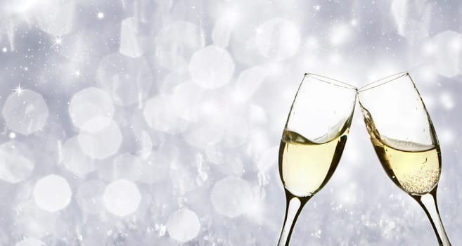 Champangne glasses on sparkling background