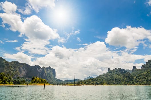 Sun over beautiful lake and mountain at Ratchapapha dam in Khao Sok National Park, Surat Thani province, Guilin of Thailand.