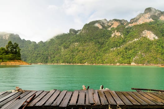 Mountain and river front of the hut while it was raining in Ratchaprapha Dam at Khao Sok National Park, Surat Thani Province, Thailand