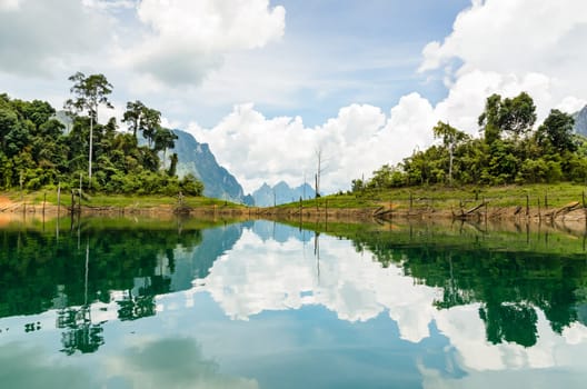 Water surface reflecting sky and cloud at Ratchapapha dam in Khao Sok National Park, Surat Thani province, Guilin of Thailand.