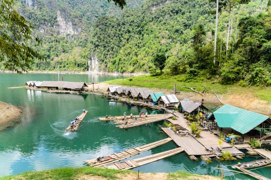SURAT THANI, THAILAND - APR 26, 2013 : The arrival of tourists to go visit the stalactite cave by motor raft in Ratchaprapha Dam at Khao Sok National Park, APR 26, 2013 in Thailand