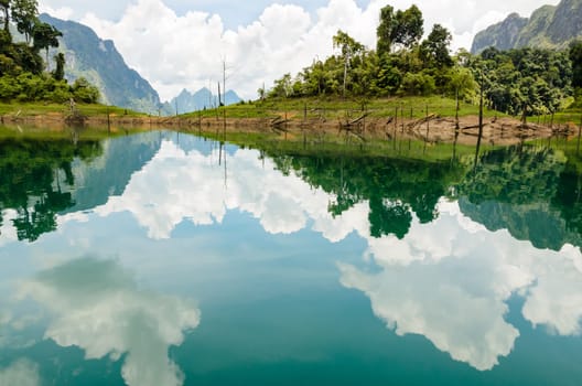 Water surface reflecting sky and cloud at Ratchapapha dam in Khao Sok National Park, Surat Thani province, Guilin of Thailand.