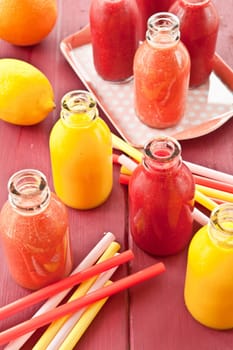 Smoothies from various fruits in small bottles