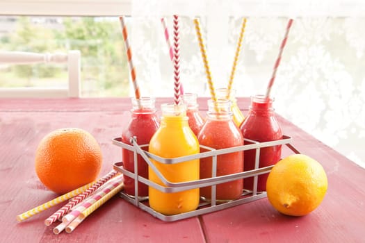 Smoothies from various fruits in small bottles