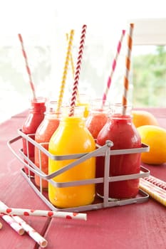 Smoothies from various fruits in small bottles