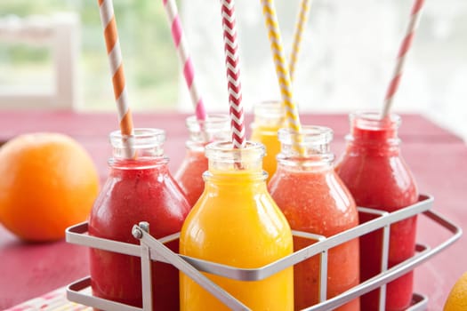 Smoothies from various fruits in small bottles