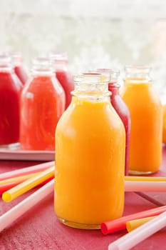 Smoothies from various fruits in small bottles