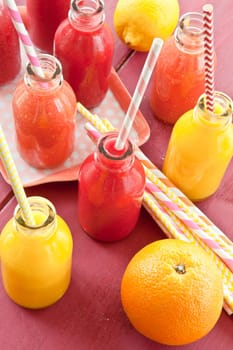 Smoothies from various fruits in small bottles