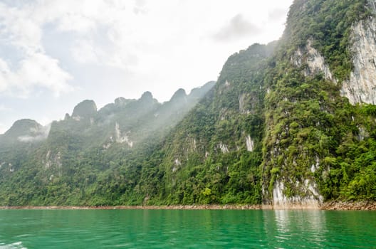 Beautiful high mountains and river in the morning at Ratchaprapha Dam, Khao Sok National Park, Surat Thani Province, Thailand