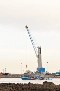 Crane for lifting a load up and down the ship in deep water harbor area of Thailand