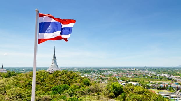 Thai flag waving on mountain in Phra Nakhon Khiri temple, archaeological site of Phetchaburi Province, Thailand.