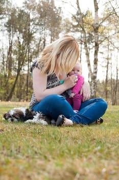 Mother is having a trip with the baby and dog outside