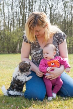 Mother is having a trip with the baby and dog outside