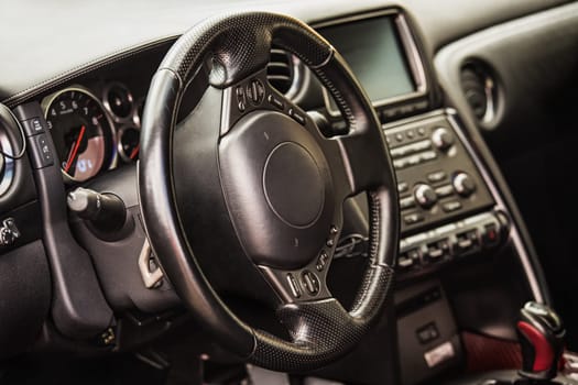 Steering wheel and dashboard in interior of the sports car