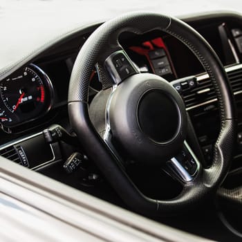 Steering wheel in interior of the sports car