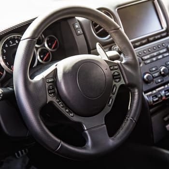 Steering wheel in interior of the sports car