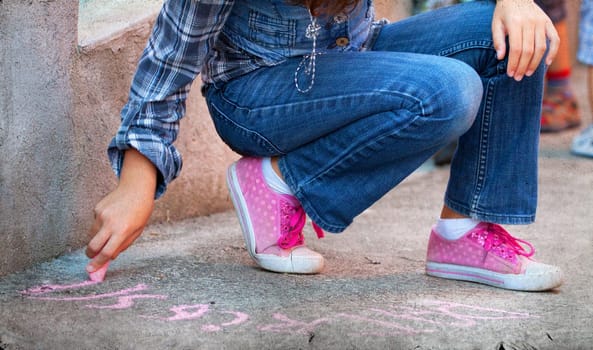 Back to school concept -Photo of girl writing with chalk on the schoolyard