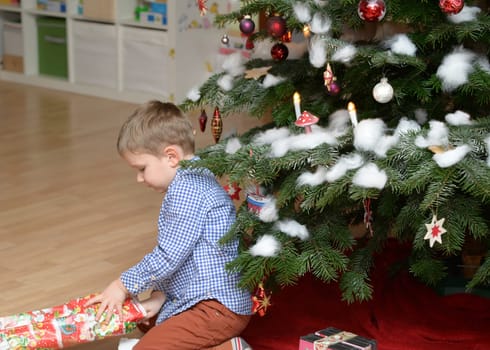 boy on christmas tree