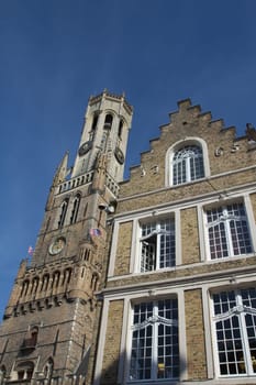 Historic House and famous Belfry tower in the background (Bruges, Belgium)