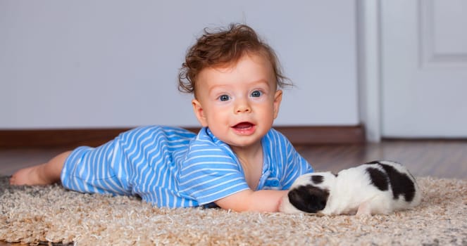7 months old baby boy playing with new born pup.