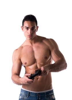 Muscular shirtless young man playing a video game with joystick in hands, isolated on white