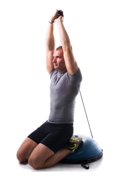 Sexy muscular man, working out with elastics, isolated on white