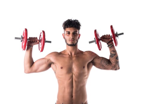 Handsome shirtless muscular young man exercises with dumbbells poses isolated on white