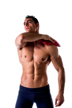Muscular young man with shoulder pain, holding hot water bottle isolated on white