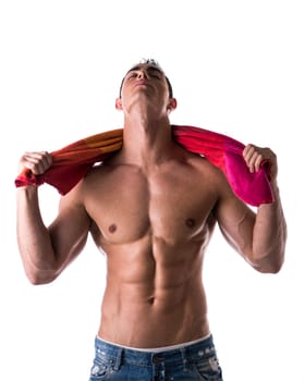 Hunky male model drying himself with a red towel on white background