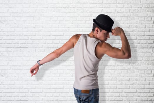 Hip young man wearing a hat dancing