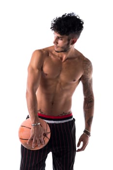 Young athletic man isolated on white background holding basketball ball, looking to a side, front view