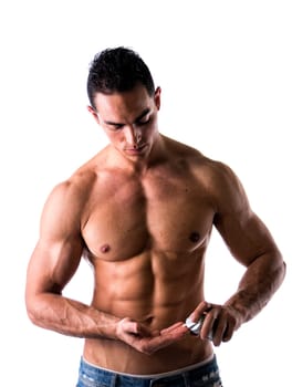 Macho male model putting shaving cream in his hand on white background