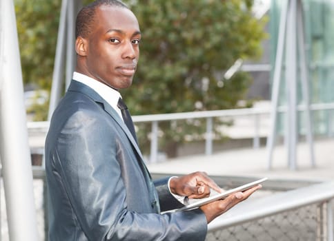 Portrait of a businessman using an electronic tablet