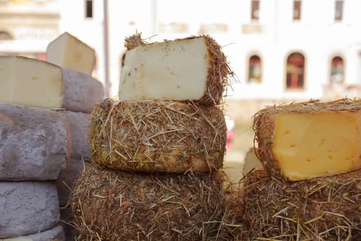 Italian cheeses covered in a layer of hay or cinder