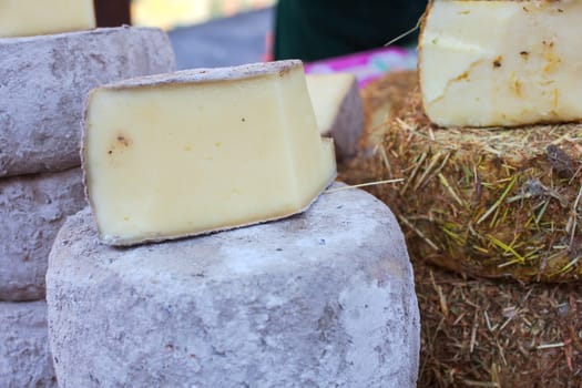 Italian cheeses covered in a layer of hay or cinder