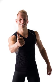 Fit male model with a big smile giving a thumbs up on white background