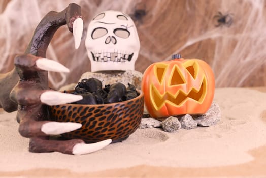 Halloween witch hand reaching for a bowl of rats