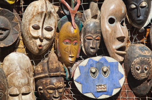 Traditional african masks hanging for sell in a market stall