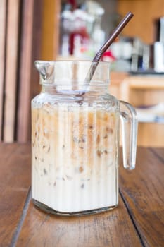 Iced coffee latte serving in glass pitcher, stock photo