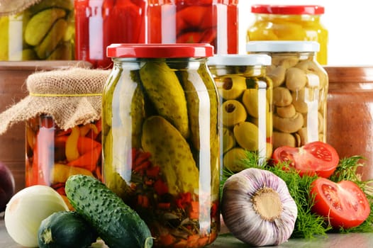 Composition with jars of pickled vegetables. Marinated food