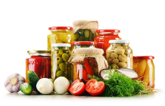 Composition with jars of pickled vegetables. Marinated food