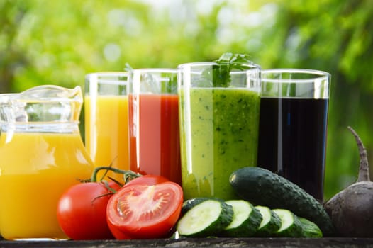 Glasses with fresh vegetable juices in the garden. Detox diet.